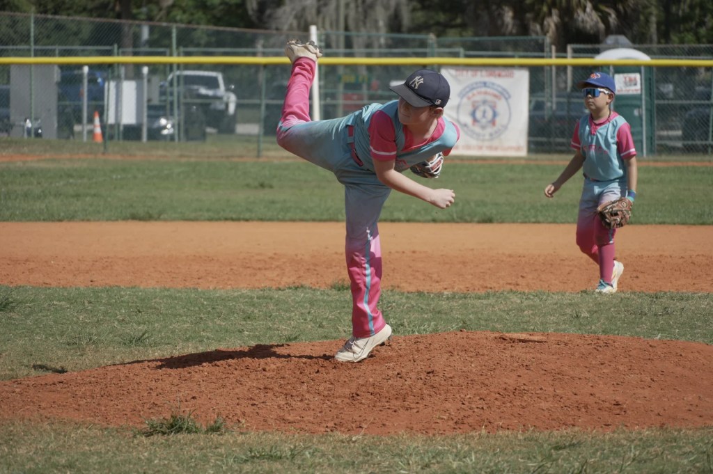 Youth pitcher following through on the mound