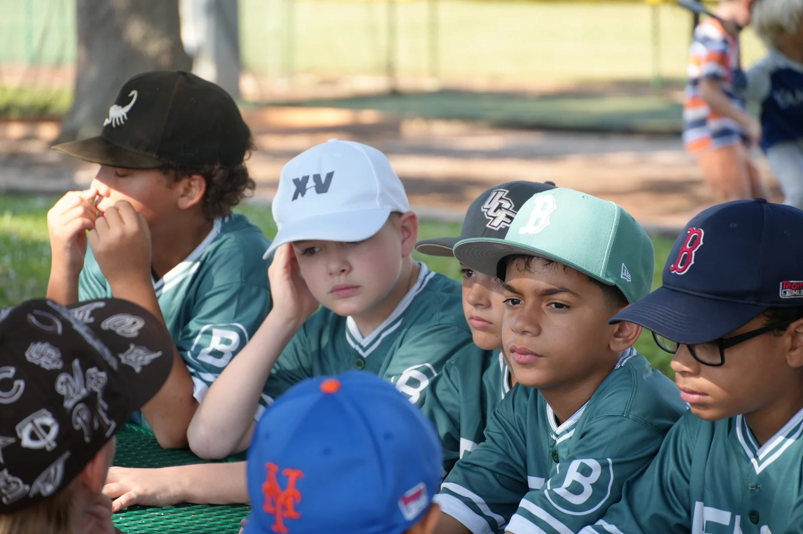 Youth baseball players watching from the dugout