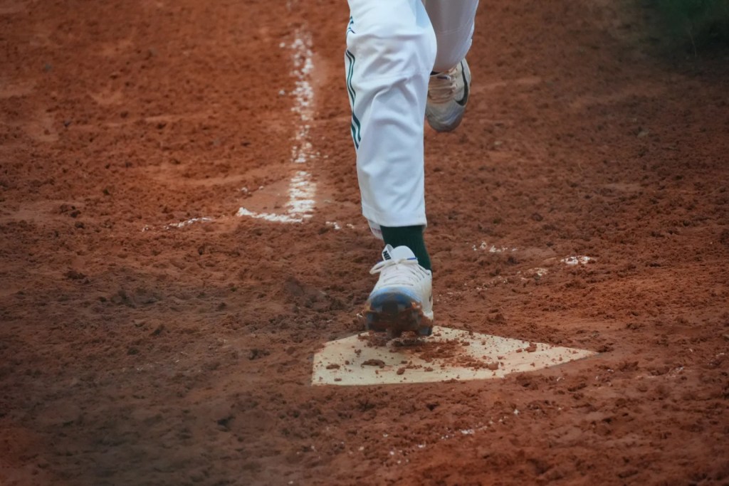 Runner's cleat touching home plate