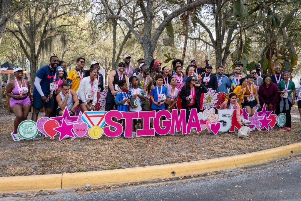 Race day group photo in front of the event sign