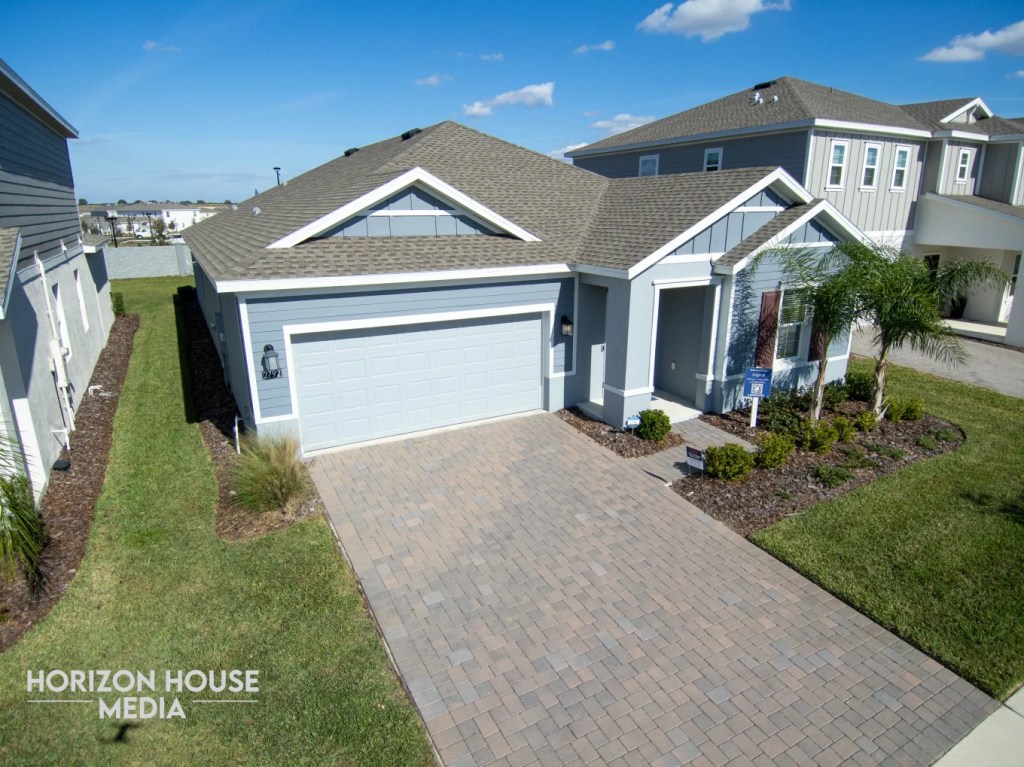 Aerial view of a single-family home and driveway